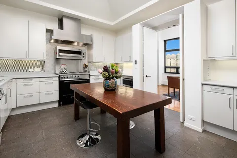 a kitchen with stainless steel appliances a sink a stove and refrigerator