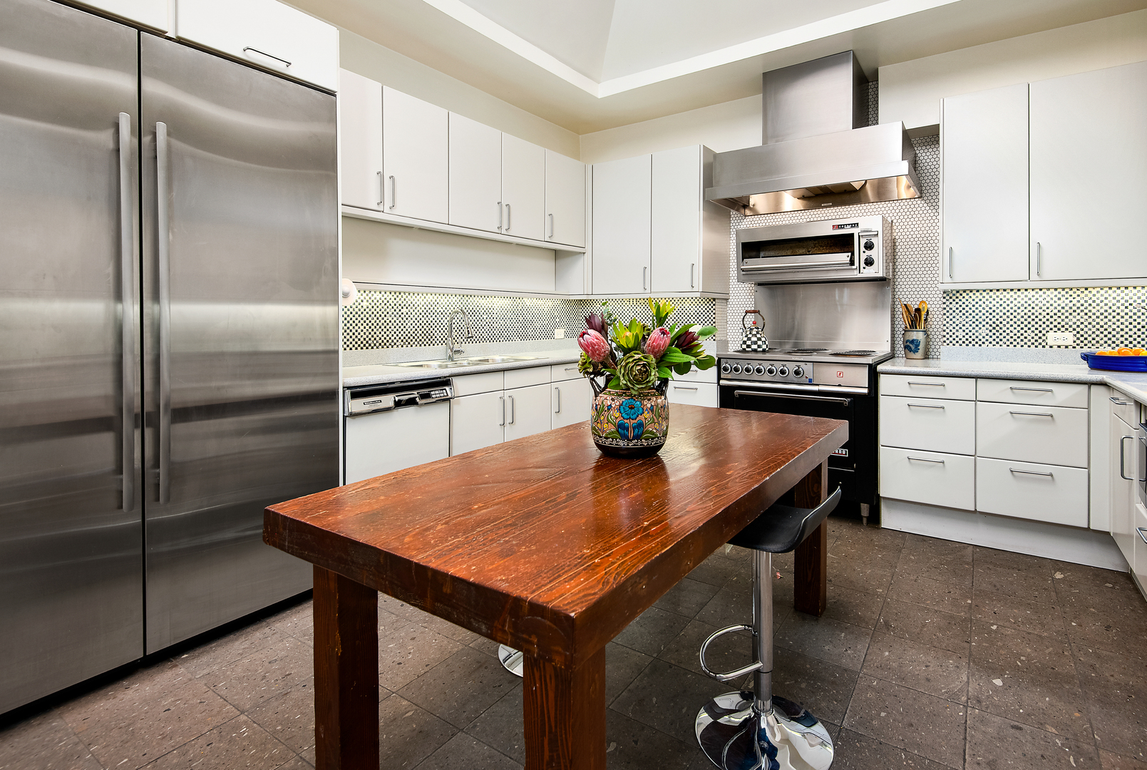 680 North Lake Shore Drive, Unit 1602 Chicago, IL 60611 - Photo 10 of 30 a kitchen with stainless steel appliances a sink a stove and refrigerator