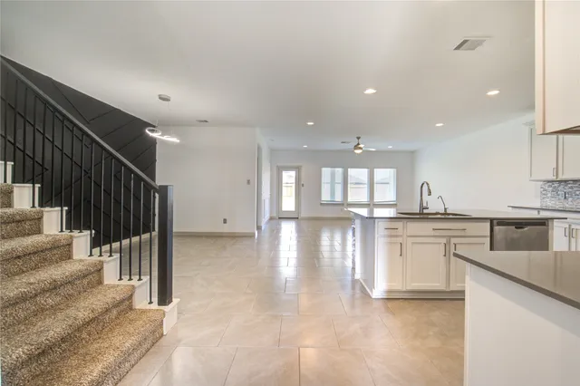 a kitchen with stainless steel appliances granite countertop a stove a sink and a refrigerator