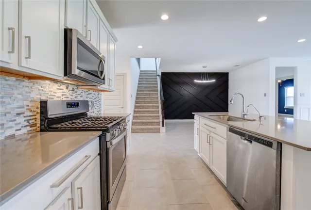 a kitchen with a sink and cabinets