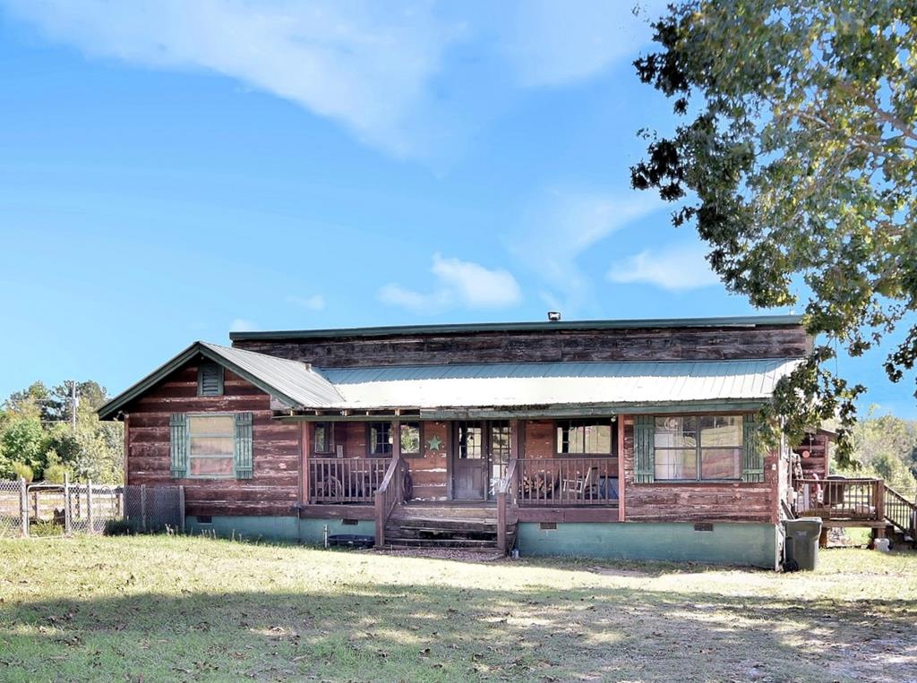 13 Lakeridge Road Seale, AL 36875 - Photo 1 of 24 a front view of a house with a yard and garage