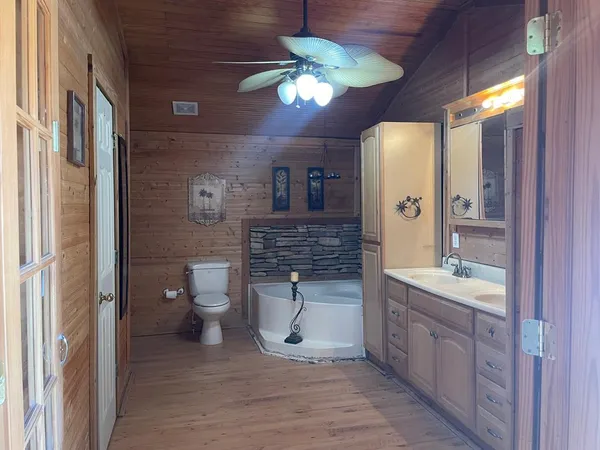 a view of a room that has a window and brick wall