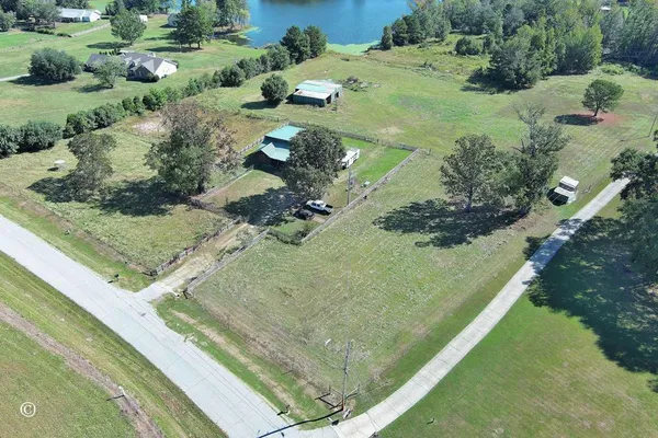 an aerial view of a house with a yard