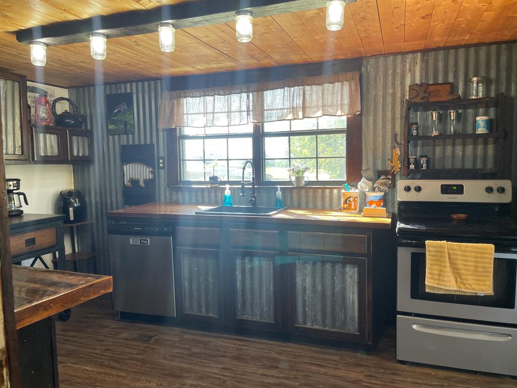 13 Lakeridge Road Seale, AL 36875 - Photo 7 of 24 a kitchen with a sink and wooden cabinets
