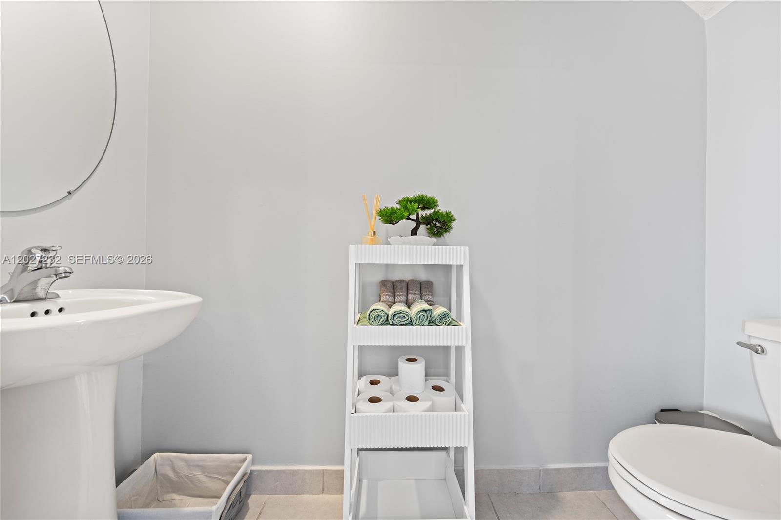 23489 Southwest 127th Place Homestead, FL 33032 - Photo 6 of 24 a bathroom with a sink a toilet and mirror