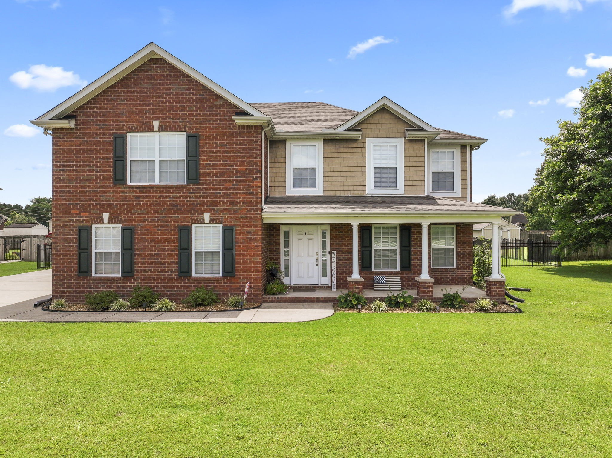 a front view of a house with garden and porch