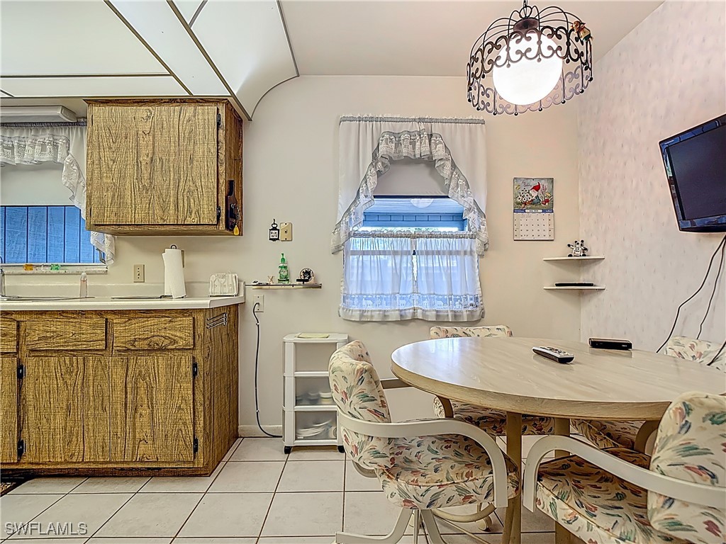 19040 Geranium Road Fort Myers, FL 33967 - Photo 18 of 42 a kitchen with stainless steel appliances granite countertop a sink and cabinets