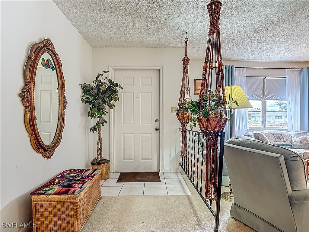 19040 Geranium Road Fort Myers, FL 33967 - Photo 3 of 42 a view of front door with potted plant