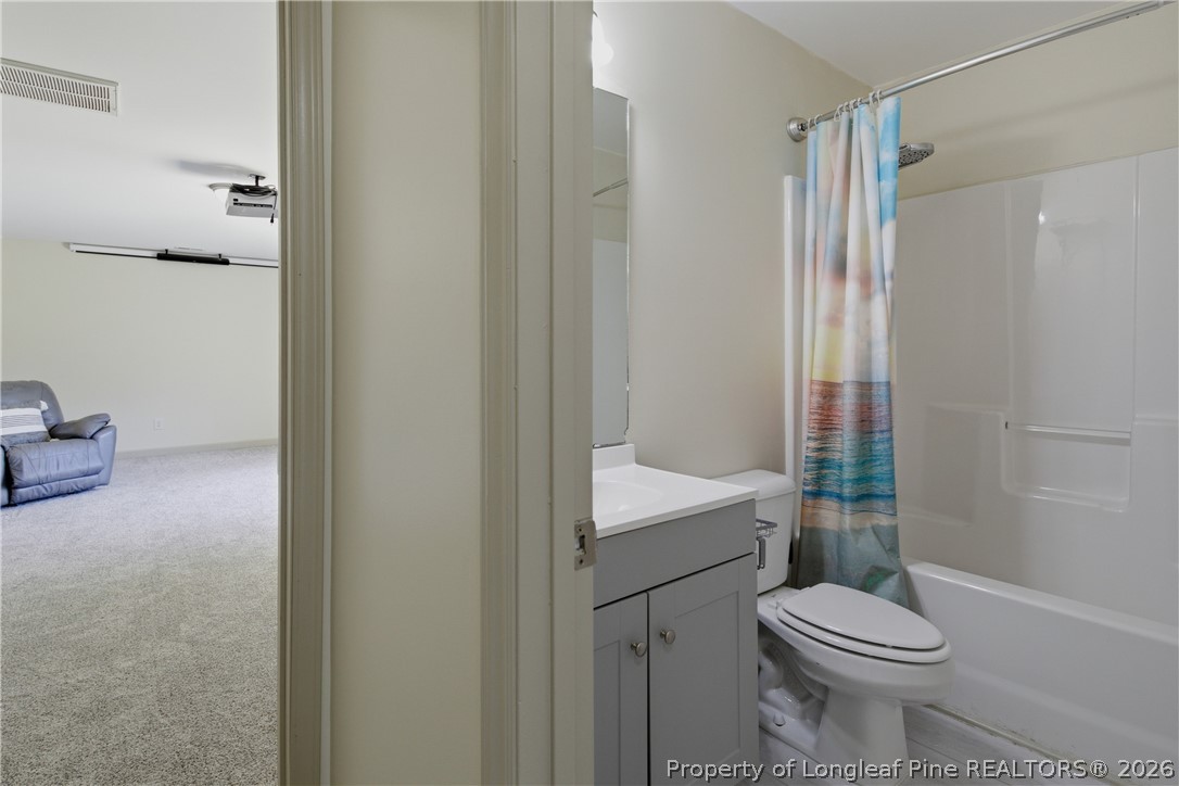 1075 Buffalo Lake Road Sanford, NC 27332 - Photo 36 of 49 a bathroom with a sink a toilet a mirror and shower