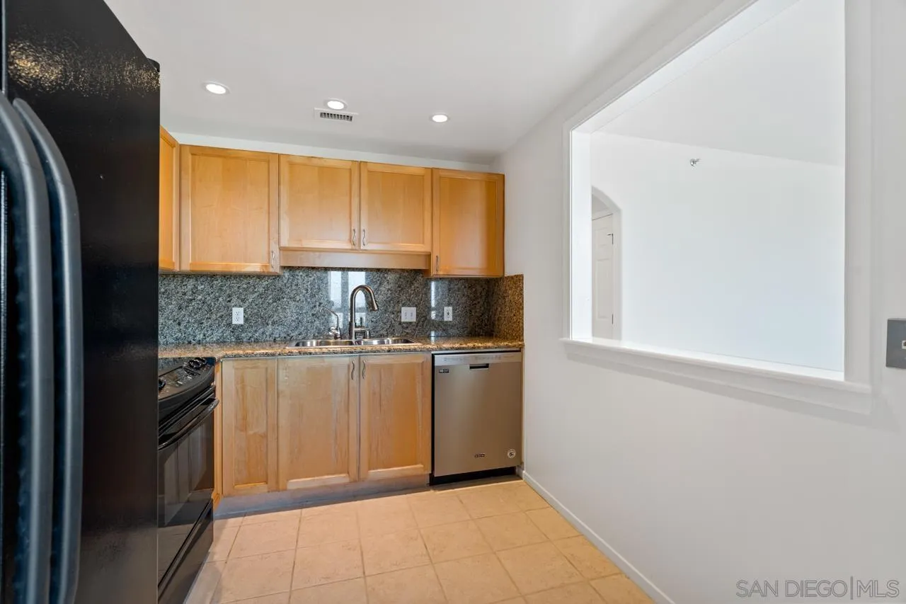 3890 Nobel Drive, Unit 1203 San Diego, CA 92122 - Photo 9 of 22 a kitchen with stainless steel appliances granite countertop a refrigerator and a sink
