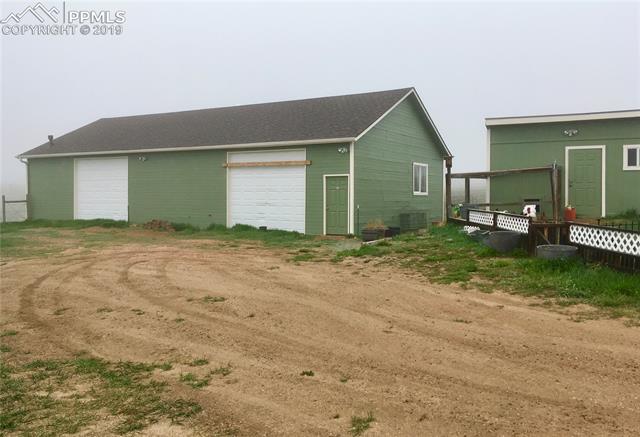 13415 Mc Cune Road Elbert, CO 80106 - Photo 3 of 8 Large shop/garage with new roof, plumbing, power and heat!! Chicken coop to the right.
