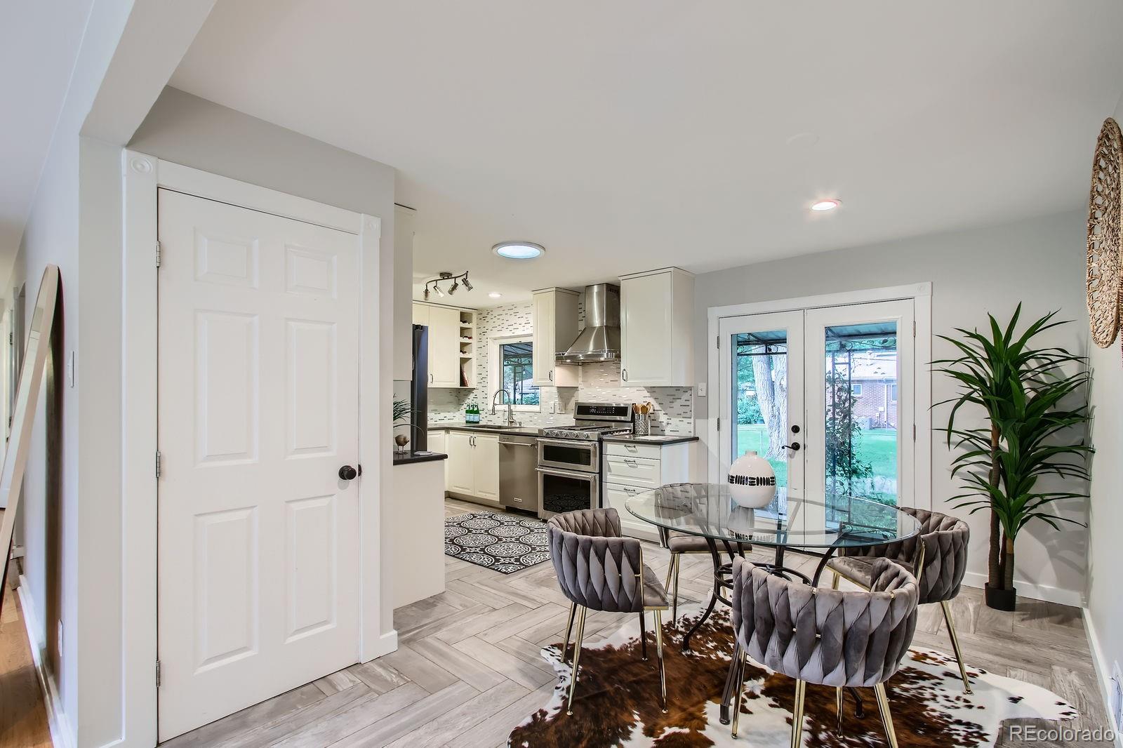 6314 Brooks Drive Arvada, CO 80004 - Photo 13 of 50 a view of a livingroom with furniture a fireplace and wooden floor