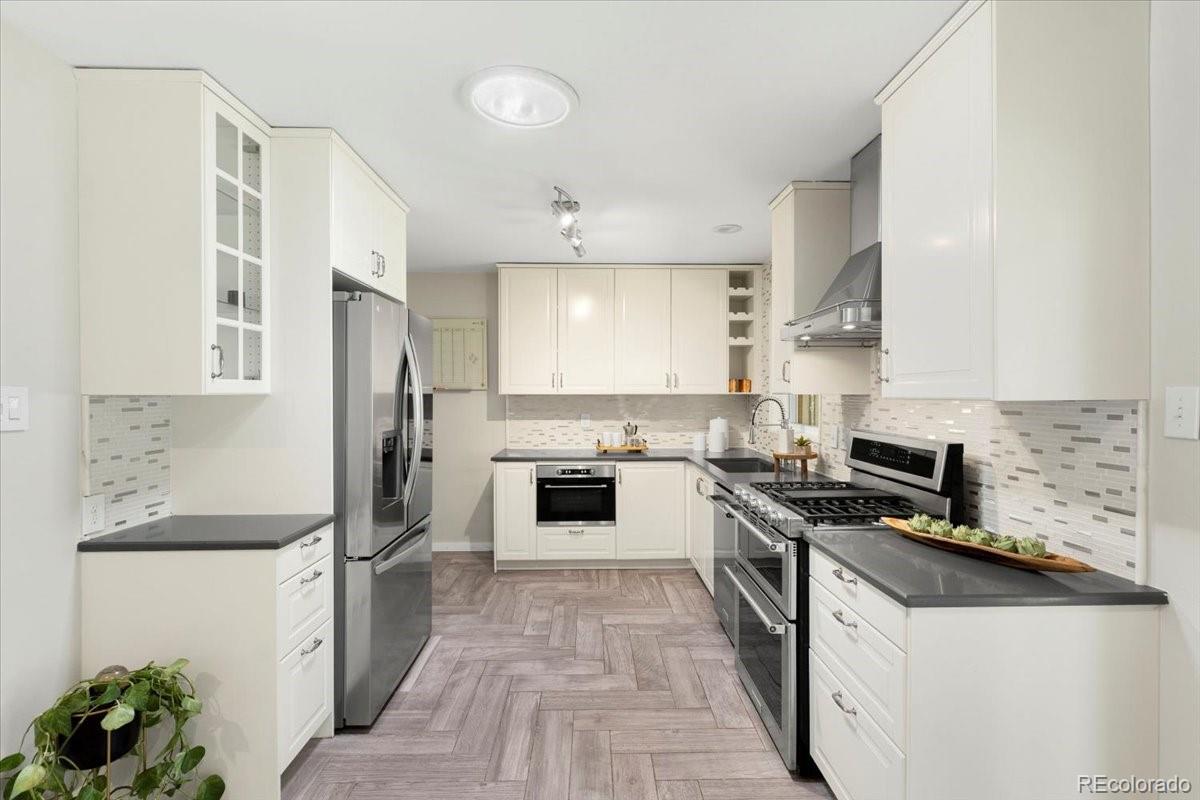 6314 Brooks Drive Arvada, CO 80004 - Photo 15 of 50 a kitchen with stainless steel appliances a refrigerator sink and stove