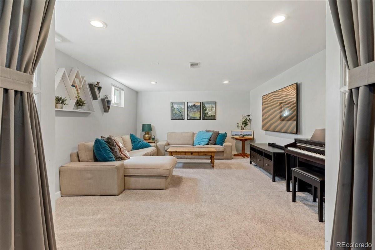 6314 Brooks Drive Arvada, CO 80004 - Photo 22 of 50 a living room with furniture and a flat screen tv