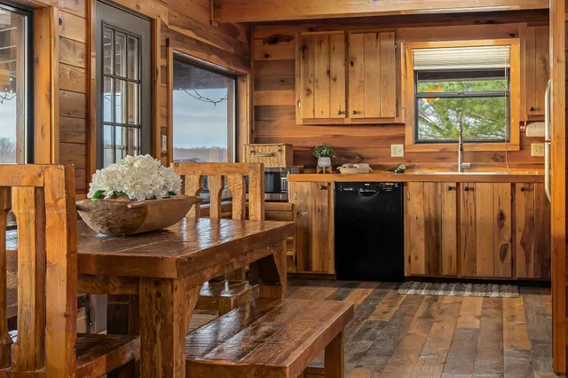 a view of a kitchen with stainless steel appliances granite countertop a stove and a refrigerator