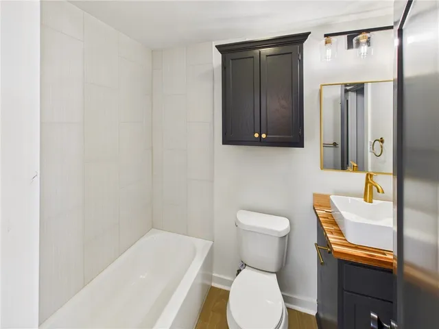 a white toilet sitting next to a bathroom sink