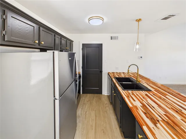 a kitchen with stainless steel appliances a refrigerator and a sink