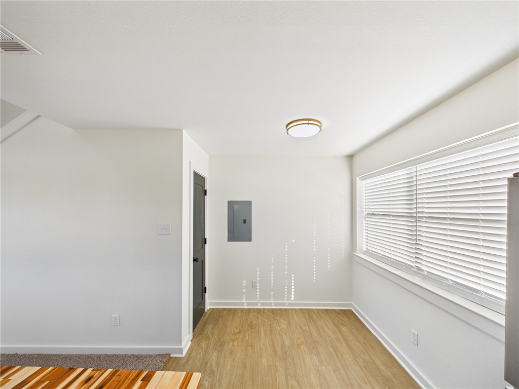 309 Mobile Avenue, Unit 6 Bryan, TX 77801 - Photo 9 of 12 Spare room with light wood-type flooring and electric panel