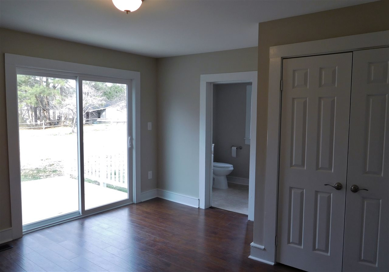 1770 Cooper Branch Road Clayton, NC 27520 - Photo 14 of 24 Beautiful hand-scraped dark wood laminate flooring leads to sliding floor with private deck! Master Bedroom