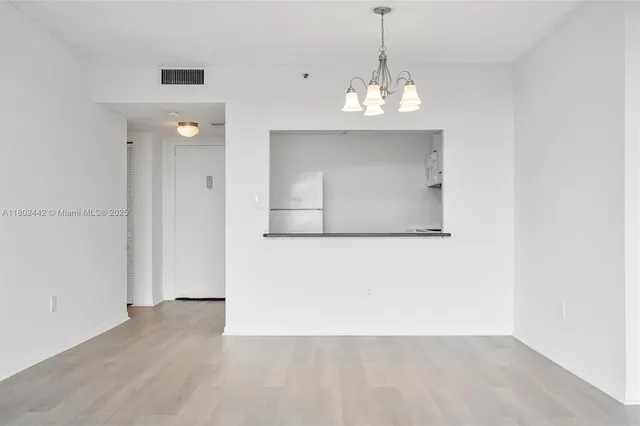 a kitchen with stainless steel appliances granite countertop a stove a sink and white cabinets