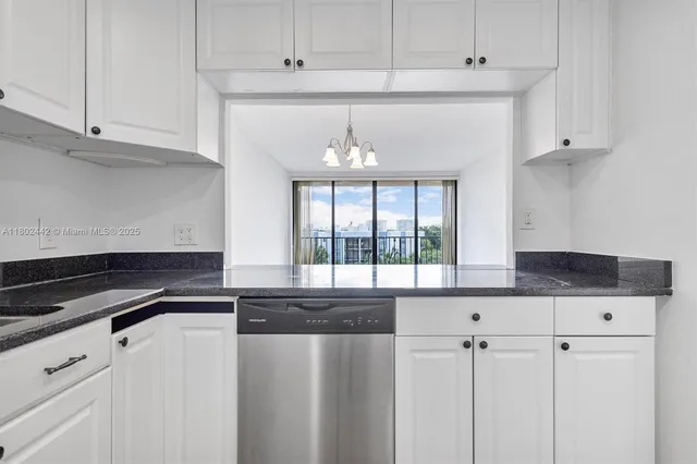 a view of a kitchen with refrigerator and faucet