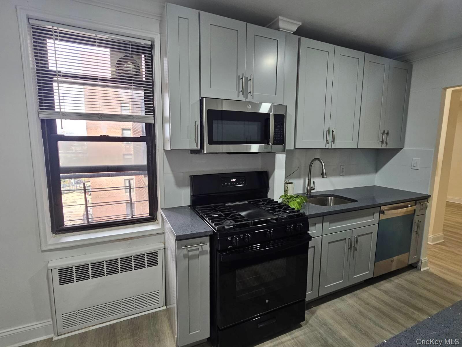 a kitchen with stainless steel appliances granite countertop a stove and a microwave