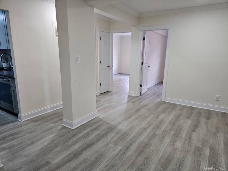 150-11 72nd Road, Unit 4D Queens, NY 11367 - Photo 13 of 13 an empty room with wooden floor and a bathroom