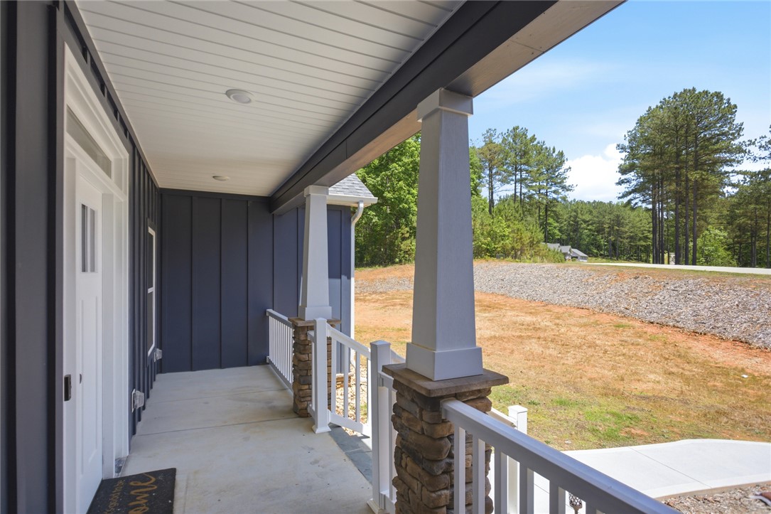 912 Watercrest Road West Union, SC 29696 - Photo 3 of 49 This inviting covered porch features stately columns, offering a warm welcome to all who enter.