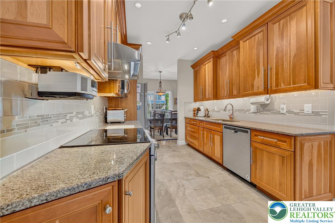 1702 Red Bud Road Quakertown, PA 18951 - Photo 16 of 68 Gleaming granite countertops and stainless appliances outfit this well-appointed kitchen.