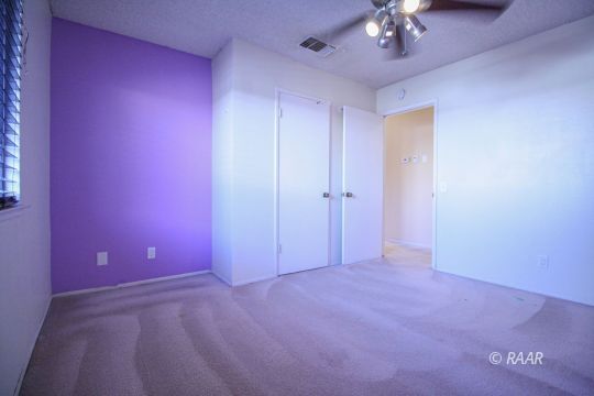 408 South Valley Street Ridgecrest, CA 93555 - Photo 13 of 29 a view of an empty room with a chandelier fan