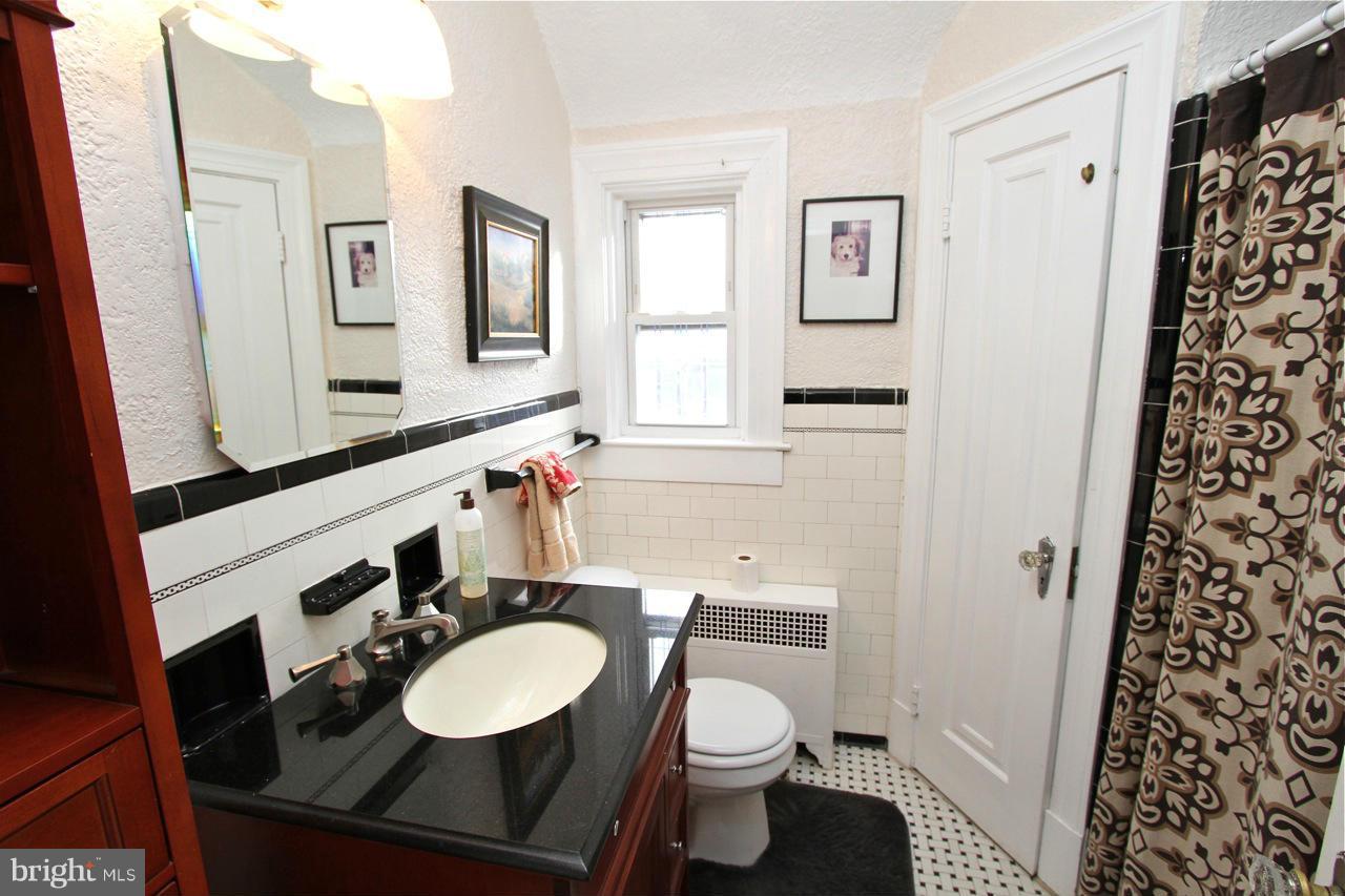404 Hopkins Road Baltimore, MD 21212 - Photo 12 of 18 a bathroom with a sink toilet vanity and shower
