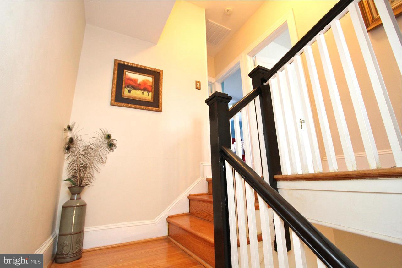 404 Hopkins Road Baltimore, MD 21212 - Photo 9 of 18 a view of staircase with railing and a potted plant