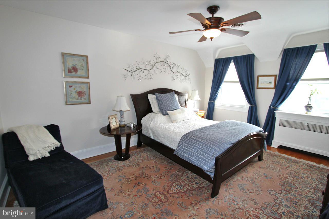 404 Hopkins Road Baltimore, MD 21212 - Photo 10 of 18 a bedroom with a bed lamp and a large window