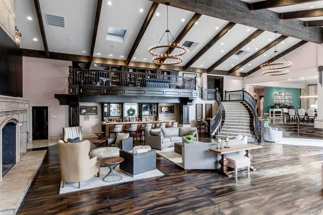 a living room with lots of furniture and kitchen view