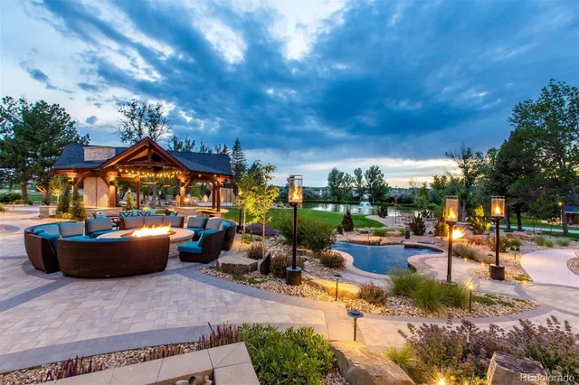 a view of a patio with couches and a fire pit