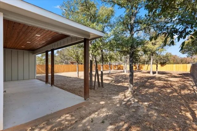 a view of a backyard with a large tree