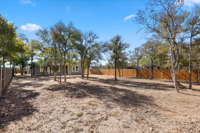 a view of a yard with trees