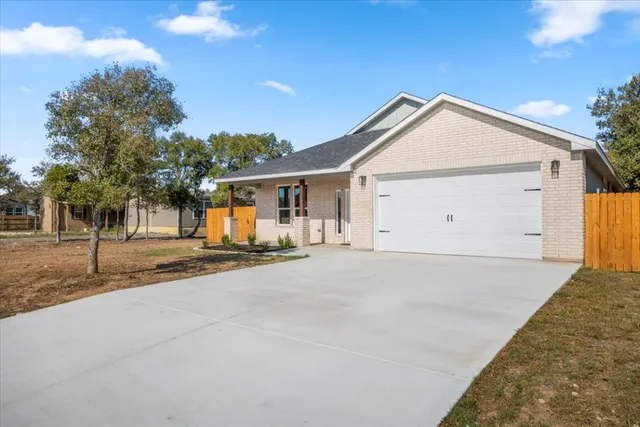 a view of a house with a yard and garage