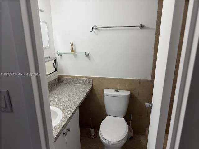 a white toilet sitting next to a sink