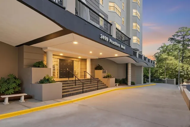 a view of a building with couches in front of house
