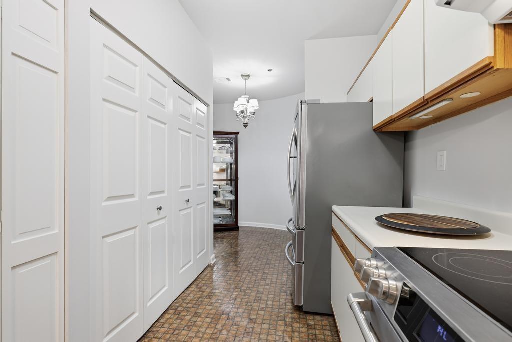 2499 Peachtree Road Northeast, Unit 306 Atlanta, GA 30309 - Photo 11 of 26 a kitchen with a refrigerator and a stove