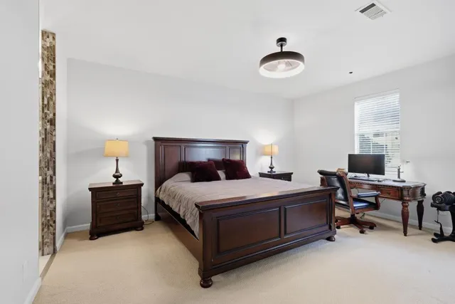 a bedroom with a bed and a table in it