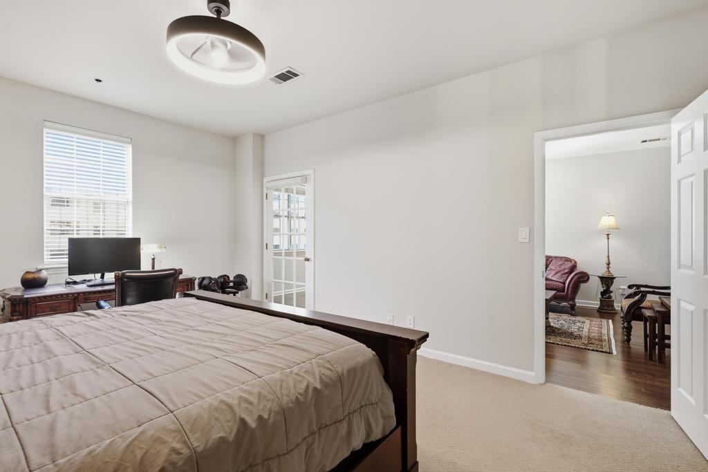 2499 Peachtree Road Northeast, Unit 306 Atlanta, GA 30309 - Photo 14 of 26 a bedroom with a bed and a chair