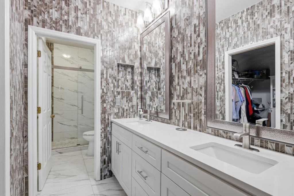 2499 Peachtree Road Northeast, Unit 306 Atlanta, GA 30309 - Photo 15 of 26 a bathroom with a shower sink and mirror