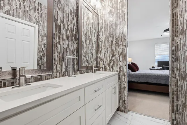 a bedroom with a bed and a large mirror