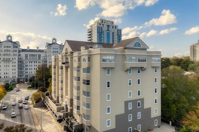 a front view of a residential apartment building with a yard