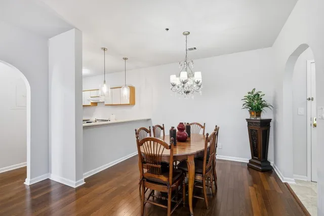 a view of a dining room with furniture wooden floor and chandelier
