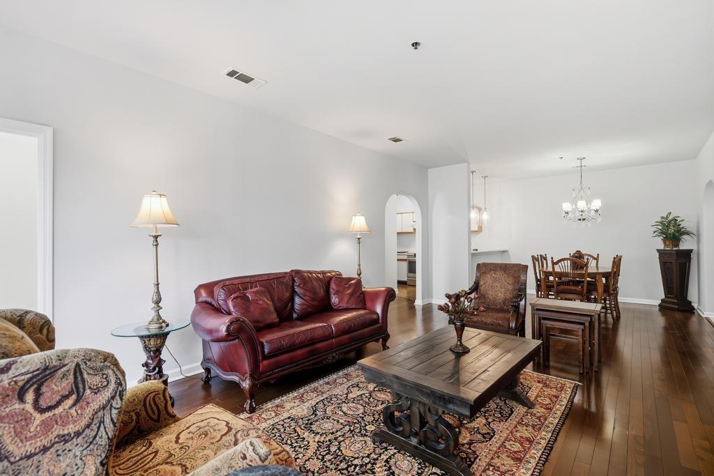 2499 Peachtree Road Northeast, Unit 306 Atlanta, GA 30309 - Photo 6 of 26 a living room with furniture a rug and a lamp