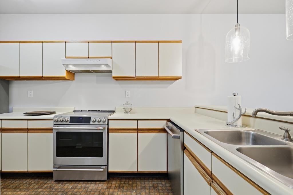 2499 Peachtree Road Northeast, Unit 306 Atlanta, GA 30309 - Photo 9 of 26 a kitchen with white cabinets and white appliances