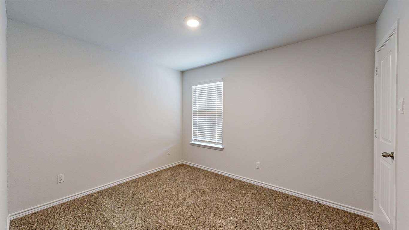 305 Creekfall Road Burnet, TX 78611 - Photo 20 of 33 an empty room with windows
